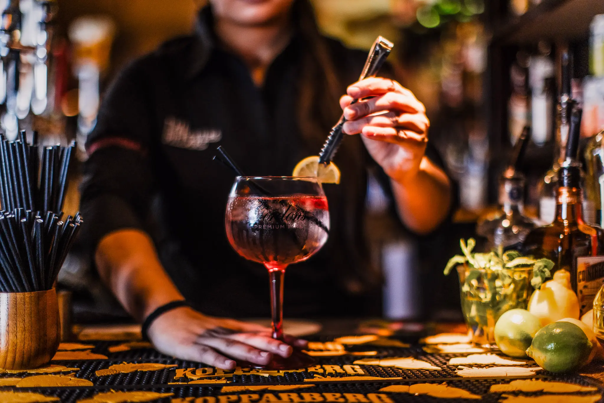 Bar staff garnishing a cocktail at The Hercules Pillars, a pub and cocktail bar in Holborn, London