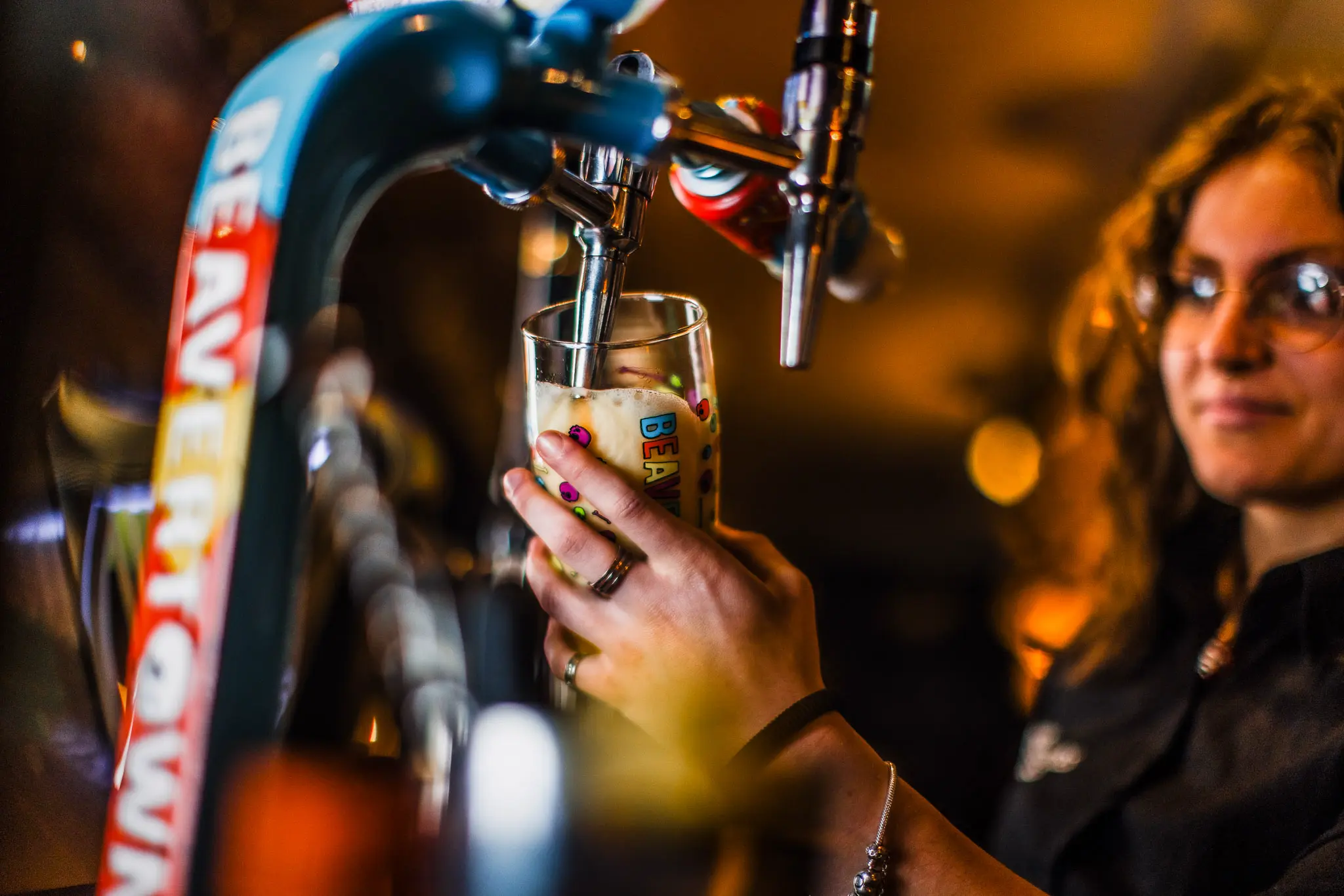 Bar staff pouring a draught beer at The Hercules Pillars, a traditional pub near Holborn station, London