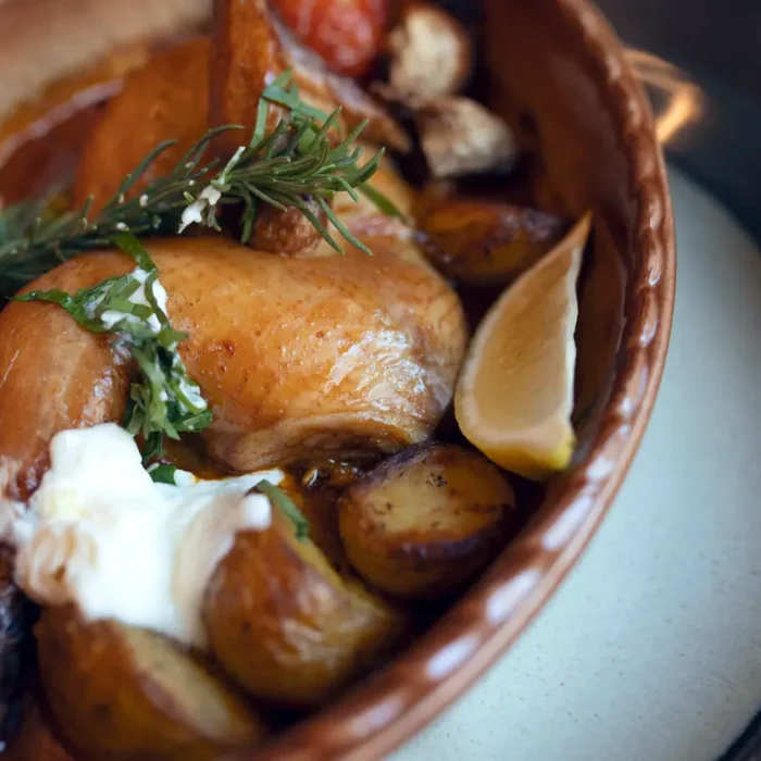 Roasted chicken with potatoes, rosemary and vegetables served as pub food in Holborn, London