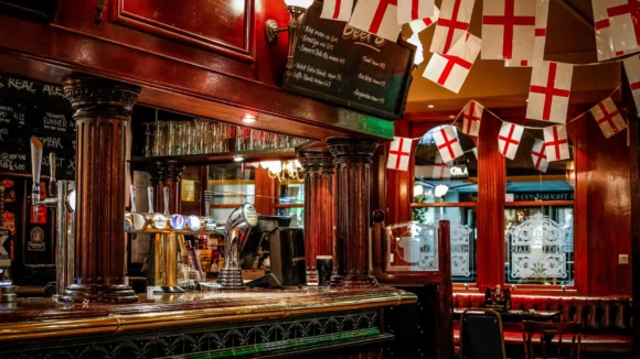 The historic bar at The Hercules Pillars in Holborn decorated with St George flags for a live sport event