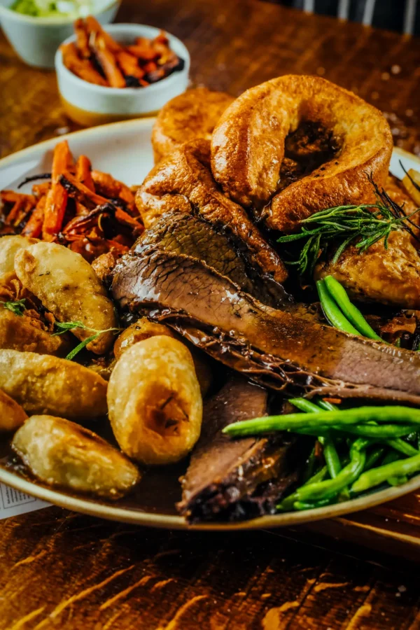Sunday roast with beef, roast potatoes, Yorkshire pudding and vegetables at The Hercules Pillars, Holborn