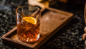 Old fashioned cocktail with orange slice served at The Hercules Pillars pub bar, Great Queen Street, Holborn