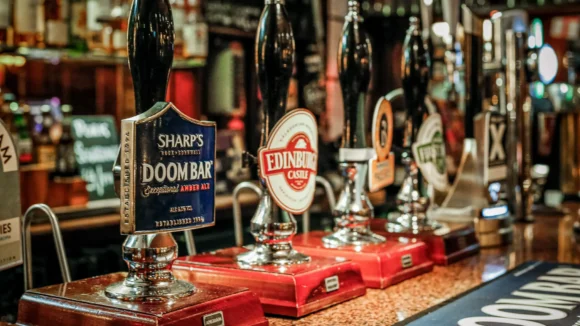 Real ale pump handles at The Hercules Pillars bar in Holborn, a Premier League pub on Great Queen Street