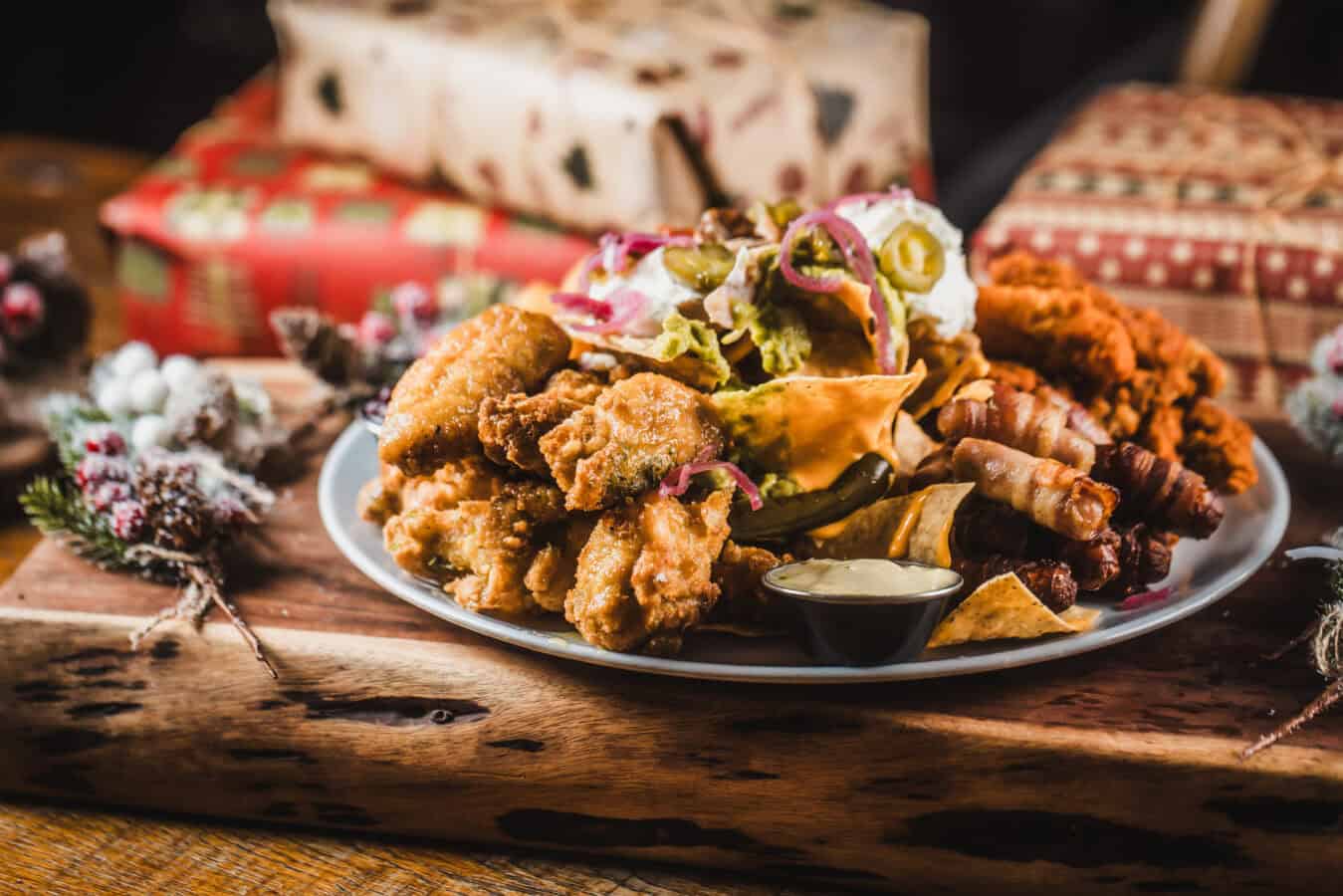 Festive food platter with fried chicken, ribs, and salad for holiday celebration.