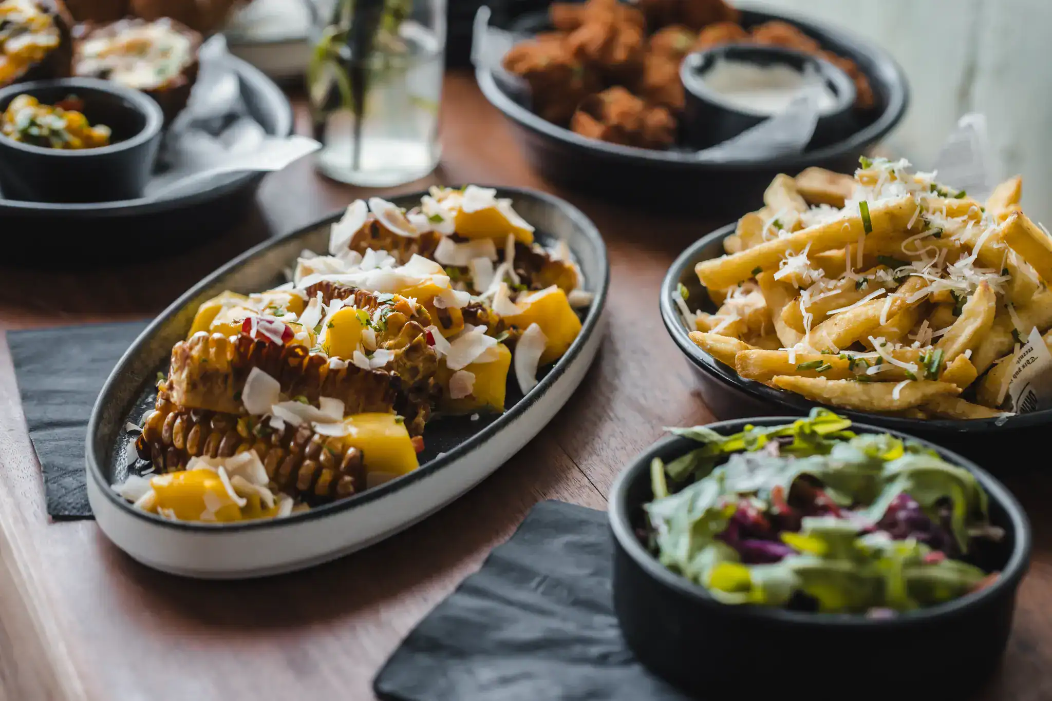 Assorted pasta, salad, and fried chicken on a dining table at Hercules Pillars.