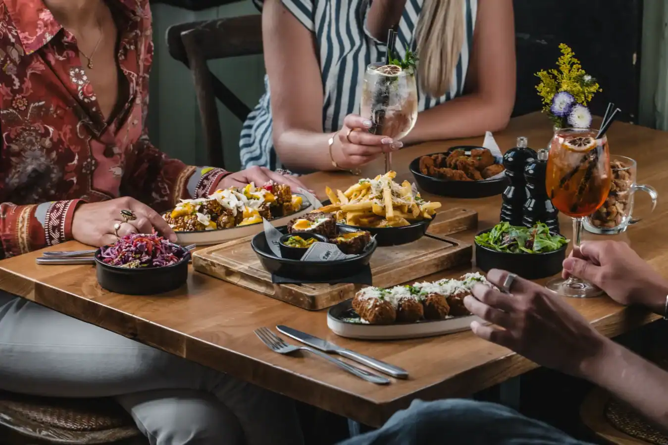 People enjoying a variety of dishes and drinks at The Hercules Pillars.