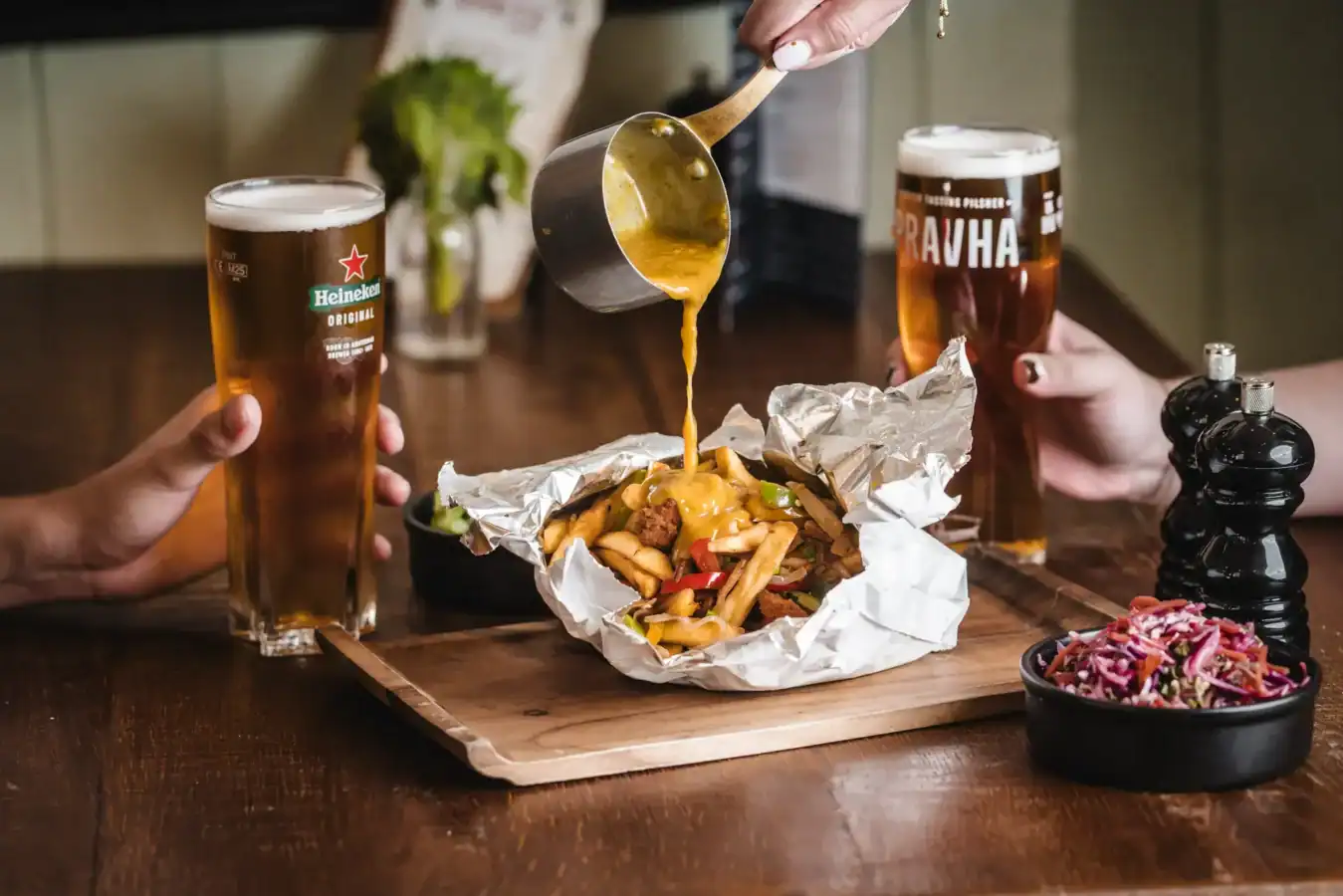 Serving beer and food at Hercules Pillars pub with friends.