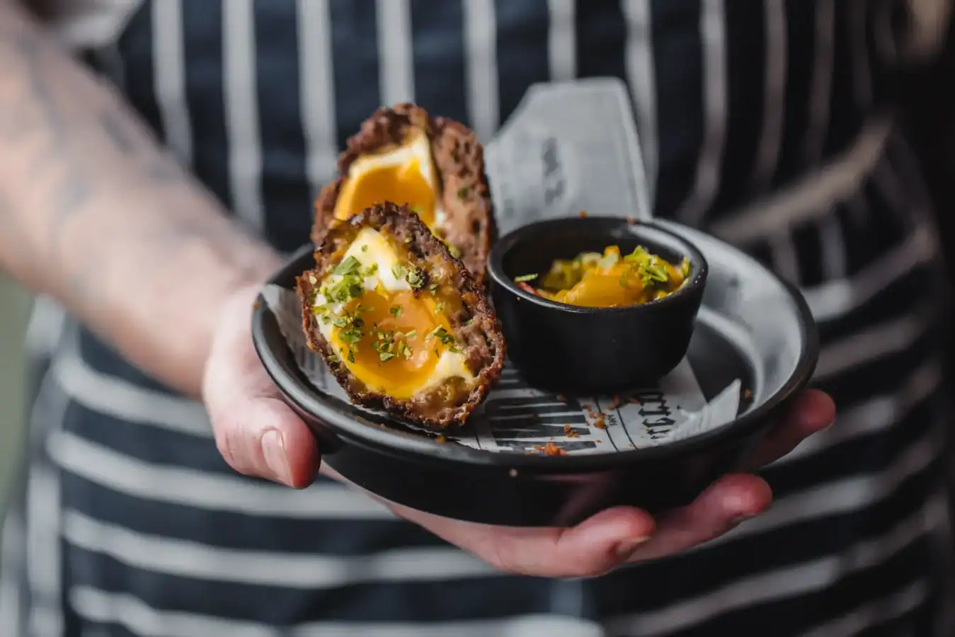 Deep-fried eggs with lemon and herbs served with dipping sauce.